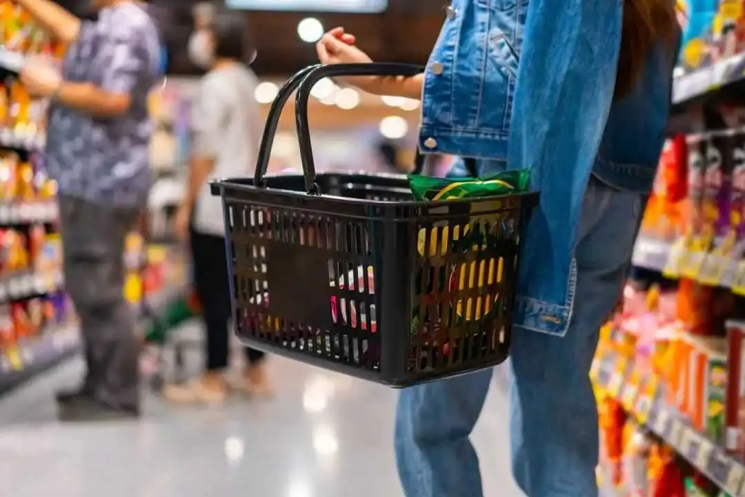 Asian woman enjoy urban lifestyle shopping at department store. Attractive girl holding supermarket basket choosing, checking price and buy food and grocery on shelf in supermarket at shopping mall.; Shutterstock ID 2528345835