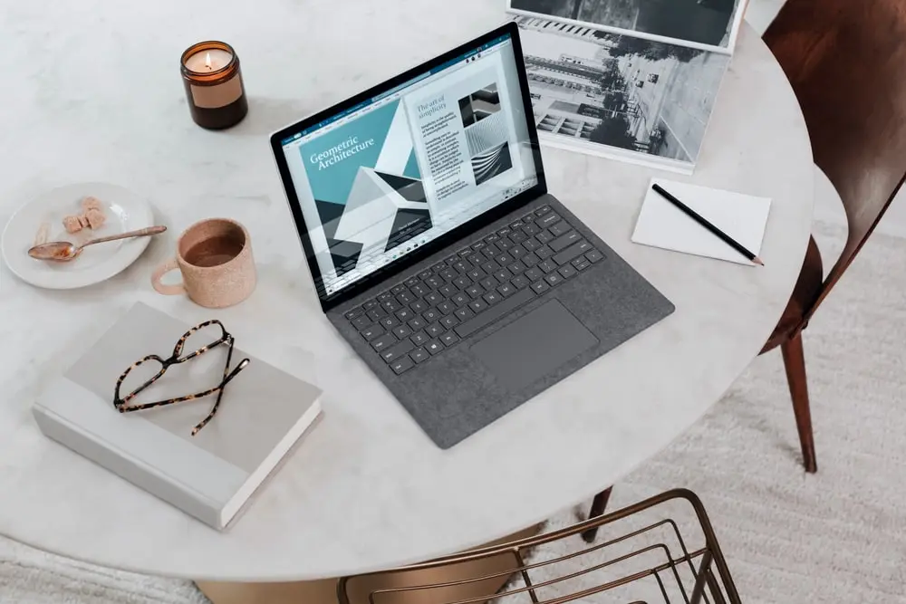 black laptop computer on round table on a Surface Laptop 