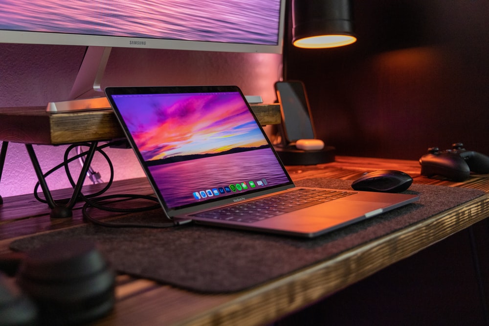 black laptop computer on brown wooden table