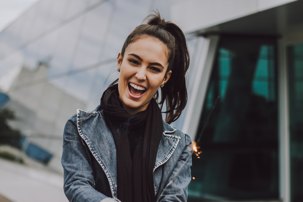 woman wearing gray denim jacket and black scarf